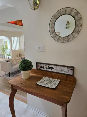 a table in a living room with a mirror at Luxury 3BR Home, 2 King Beds, Near cafes and groceries in North Vancouver
