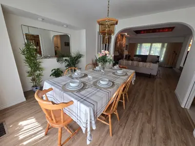 a dining room with a table with chairs and a couch at Luxury 3BR Home, 2 King Beds, Near cafes and groceries in North Vancouver
