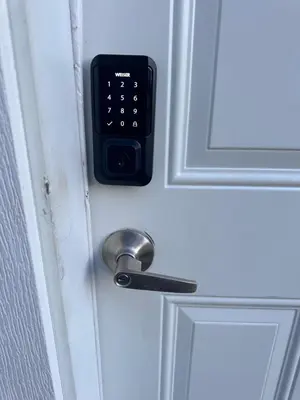 a door lock with a remote control on it at Elegant Cozy Private Apartment in Calgary