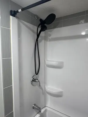 a shower with a hair dryer in a bathroom at Elegant Cozy Private Apartment in Calgary