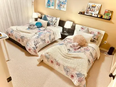a bedroom with two beds with stuffed animals on them at Scorpio House Langley in Langley