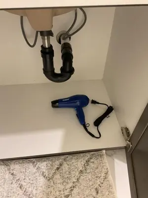 a blue phone hanging on the corner of a wall at Cozy & Stylish AC Suite Near YYC Airport in Calgary