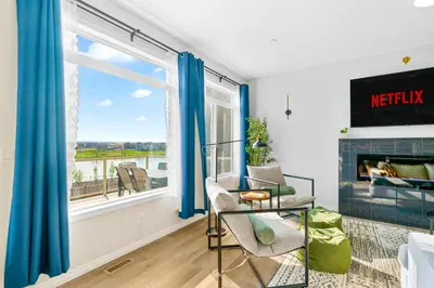 a living room with a fireplace and blue curtains at The Ultimate Getaway with Central AC, 3 King Beds, Hot Tub, Pool Table and More in Balzac