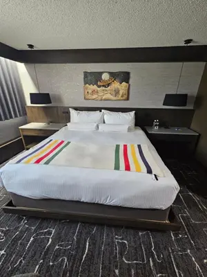 a bedroom with a large bed in a room at Grande Cache Hotel in Grande Cache