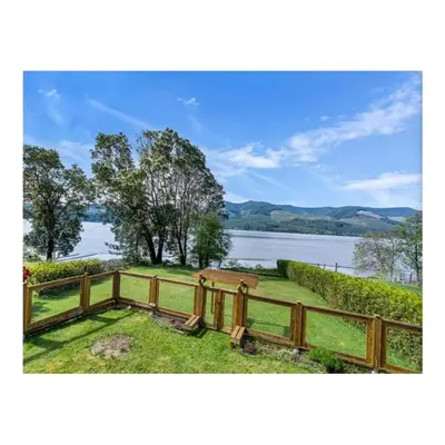a wooden fence with a view of a lake at Youbou Lakefront Getaway Relax And Unwind in Youbou