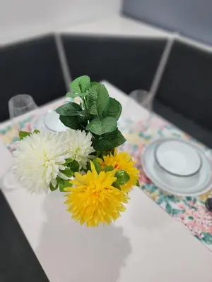 a vase filled with flowers on a table at Gorgeous Two Bedroom Suite in a Quiet, Picturesque Neighborhood! in West Vancouver