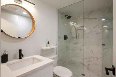 a bathroom with a toilet and a glass shower at Ravencrest 204 by Outpost Whistler in Whistler