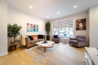 a living room with a couch and chairs and a table at RomanticStylish|FreeWifi|KingBed|WEM|parking in Edmonton