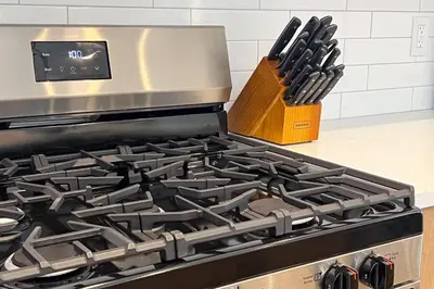 a stove top oven with a block of knives at RomanticStylish|FreeWifi|KingBed|WEM|parking in Edmonton