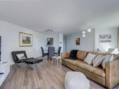 a living room with a couch and a table at Coastal Duet - min 3-Day Stay Breathtaking Views with Work Desk by Victoria Prime! in Victoria