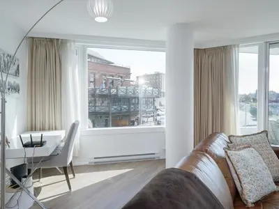 a living room with a couch and a table at Coastal Duet - min 3-Day Stay Breathtaking Views with Work Desk by Victoria Prime! in Victoria
