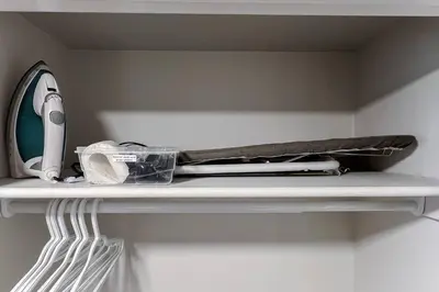 a shelf with a hair dryer and a hairdryer at ~SweetTropicalBSMTsuite~KingBed|WIFI•parking in Edmonton