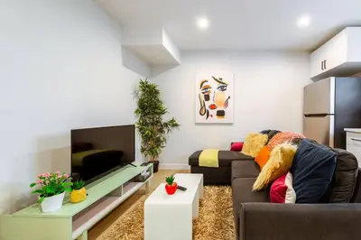a living room with a couch and a table at ~SweetTropicalBSMTsuite~KingBed|WIFI•parking in Edmonton