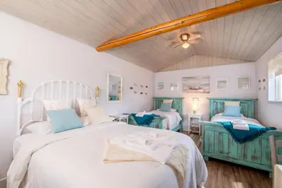a bedroom with two beds and a ceiling at Prairie Junction Rustic Cabins Stettler in Stettler