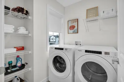 a white laundry room with a washing machine at New Luxury Sleeps 7 AC Double Garage in Edmonton