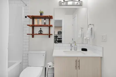 a white bathroom with a toilet and a sink at 1 BR Suite Stylish Coffee Station Stocked sleep 4 in Edmonton