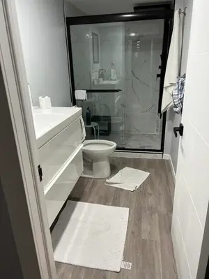 a bathroom with a toilet and a sink and a shower at Gorgeous Basement Apartment in Calgary