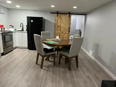 a dining room table and chairs in a kitchen at Gorgeous Basement Apartment in Calgary