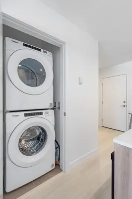 a washer and dryer in a room with a door at Modern North Shore Nest with Balcony in North Vancouver