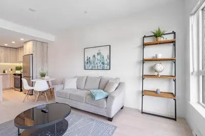 a living room with a couch and a table at Modern North Shore Nest with Balcony in North Vancouver