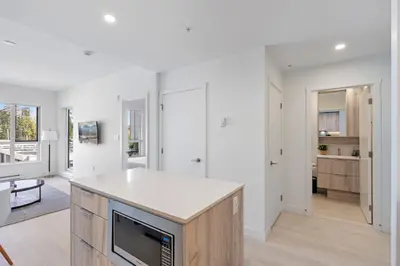 a kitchen with white walls and a white counter top at Modern North Shore Nest with Balcony in North Vancouver