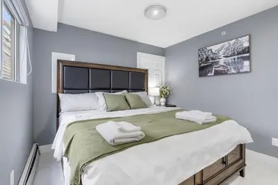a bedroom with a large bed with two towels on it at Stylish 3BR, 2BA Vancouver Home in Vancouver