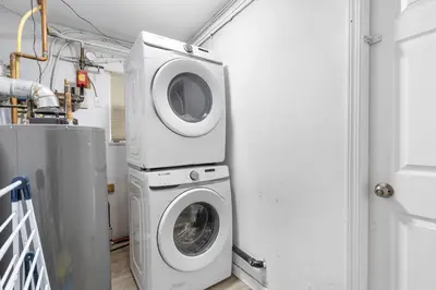 a laundry room with a washing machine and a washer at Stylish 3BR, 2BA Vancouver Home in Vancouver