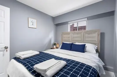 a bedroom with a blue and white bed with blue pillows at Stylish 3BR, 2BA Vancouver Home in Vancouver