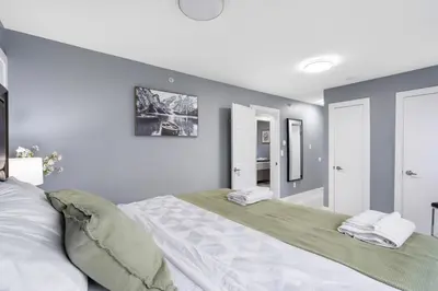 a bedroom with a large bed with two towels on it at Stylish 3BR, 2BA Vancouver Home in Vancouver