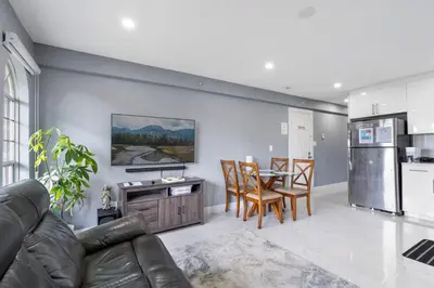 a living room with a couch and a table with chairs at Stylish 3BR, 2BA Vancouver Home in Vancouver
