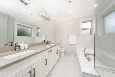 a white bathroom with a sink and a toilet at Upscale 4BR Vancouver in Vancouver