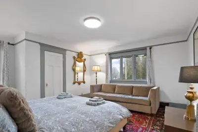 a living room with a bed and a couch at Charming 2 bedroom Duplex steps from Jericho Beach in Vancouver