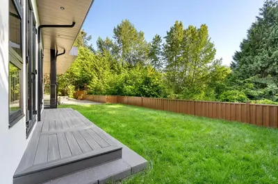 a backyard with a wooden deck and a fence at 2505 Edgemont Blvd.- Anupoju in North Vancouver