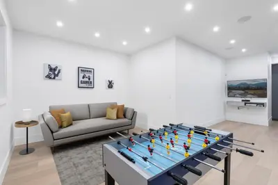 a living room with a ping pong table at 2505 Edgemont Blvd.- Anupoju in North Vancouver