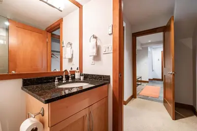 a bathroom with a sink and a mirror at Ravencrest 309 by Outpost Whistler in Whistler
