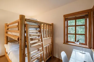 a bedroom with a bunk bed and a window at Taluswood 6 by Outpost Whistler in Whistler
