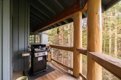 a grill on the porch of a house at Taluswood 6 by Outpost Whistler in Whistler
