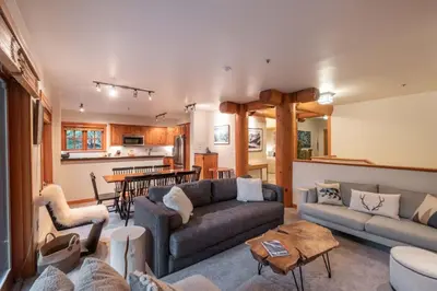 a living room with a couch and a table at Taluswood 14 by Outpost Whistler in Whistler