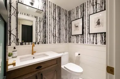 a bathroom with a toilet and a sink and a mirror at Taluswood 36 by Outpost Whistler in Whistler