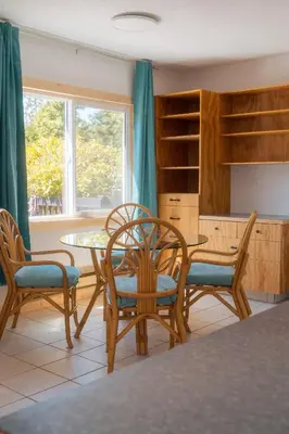 a dining room with a table and chairs and a window at Little Beach Resort in Ucluelet