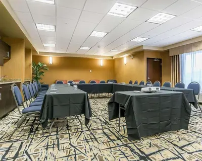 a conference room with tables and chairs in it at Comfort Inn & Suites Edmonton International Airport in Nisku