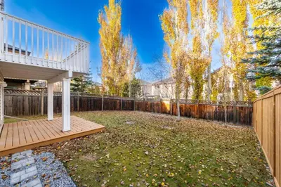 a backyard with a deck and a fence at Valley Home 2 Bed 1 Bath Walkout Basement Apartment, 1hr to Banff, 40 Mins Canmore, 5 mins to WinSport & Olympic park in Calgary