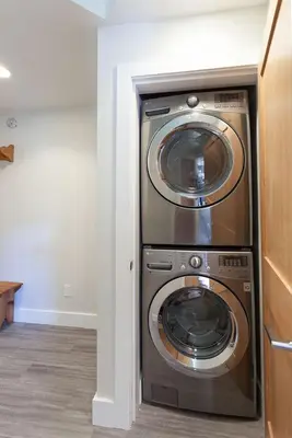 a kitchen with a washer and dryer in a room at Tyndall Stone 317 by Outpost Whistler in Whistler