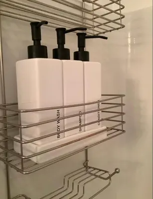 a rack with white towels on a wall at City Center Olive Grove in Kamloops
