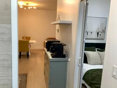 a room with a room with a bed and a desk at City Center Olive Grove in Kamloops