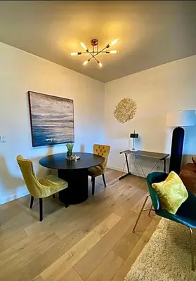 a living room with a table and chairs at City Center Olive Grove in Kamloops
