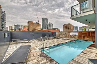 a rooftop swimming pool on top of a building at MicroNest - Modern Overlooking Downtown Parking in Calgary