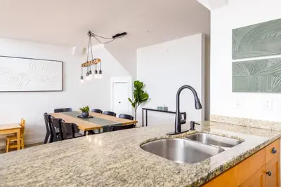 a kitchen with a sink and a dining table at Wintergreen Retreat w/Hot Tub by Village in Kelowna