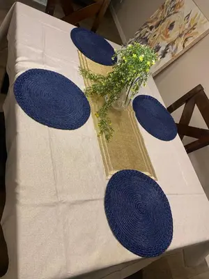 a blue and white table with a vase with flowers on it at Mahogany's Comfy Haven in Calgary