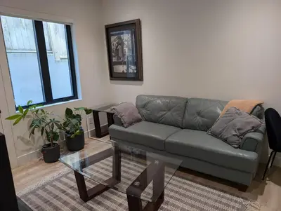a living room with a couch and a glass table at Delux 2 bedroom suite in White Rock